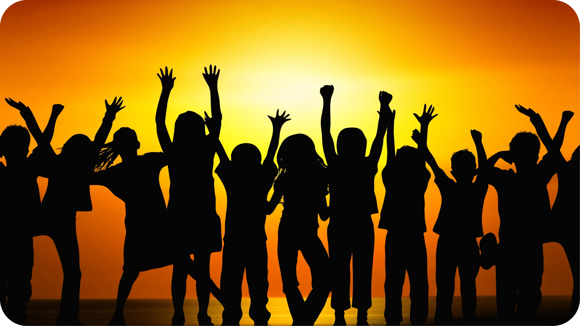 A silhouette of children in a row in front of a bright orange and yellow sunset.