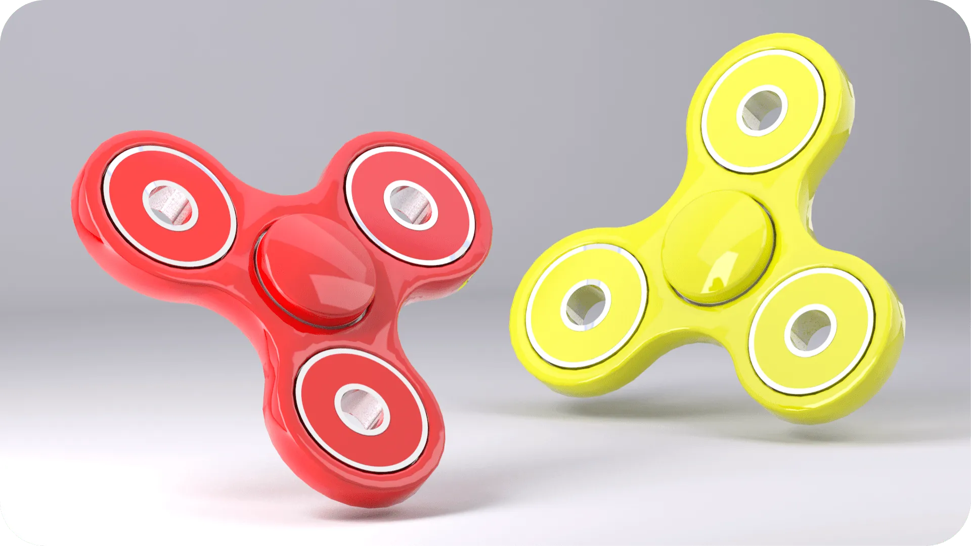Red and yellow fidget spinners on a grey background.