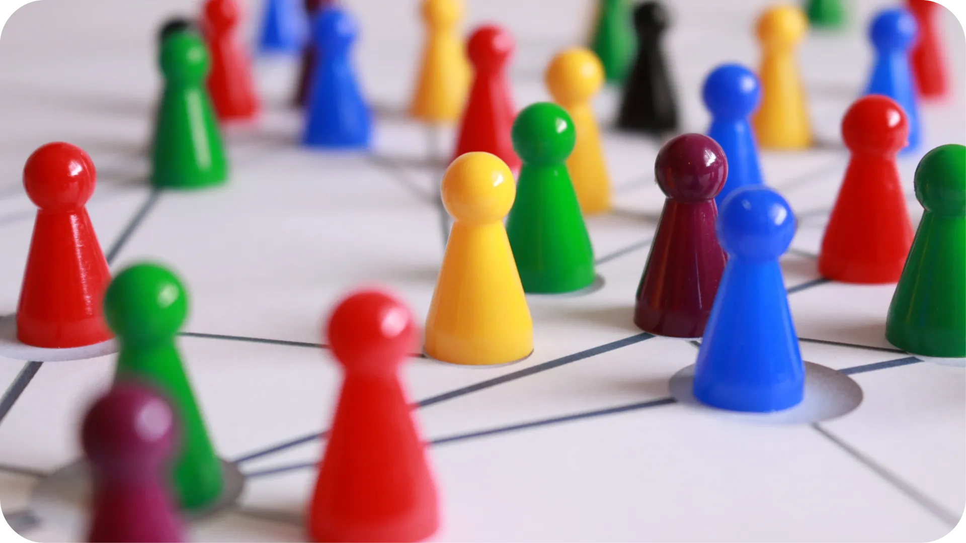 Colourful pawns on a board on dots with connecting lines.